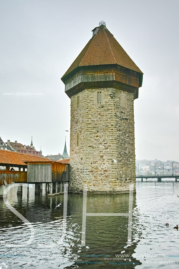 LUCERNE, SWITZERLAND - OCTOBER 28, 2015: foggy morning and Chapel Bridge over Reuss River, Lucerne, Switzerland