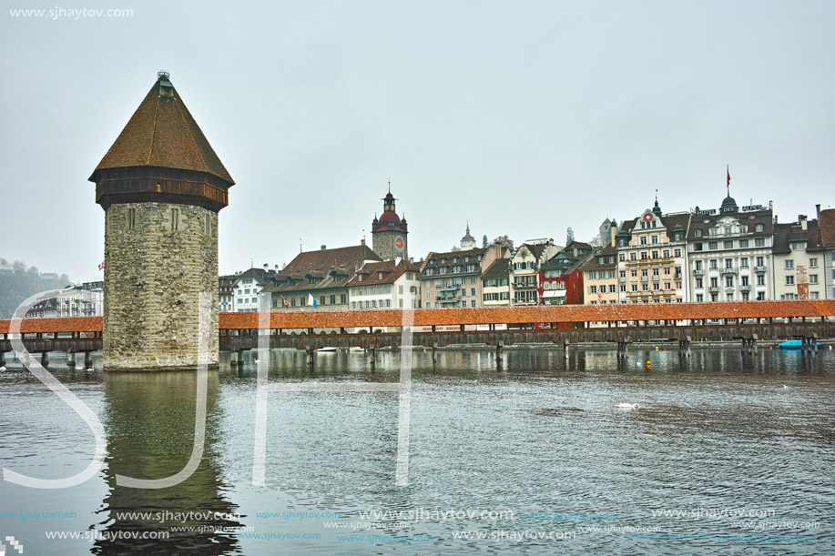 LUCERNE, SWITZERLAND - OCTOBER 28, 2015: foggy morning and Chapel Bridge over Reuss River, Lucerne, Switzerland