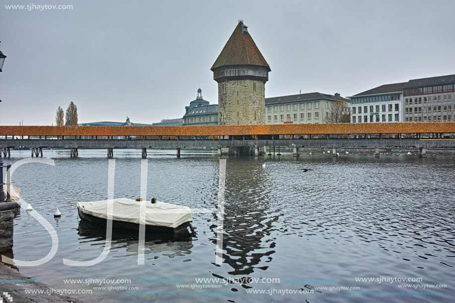 LUCERNE, SWITZERLAND - OCTOBER 28, 2015: foggy morning and Chapel Bridge over Reuss River, Lucerne, Switzerland