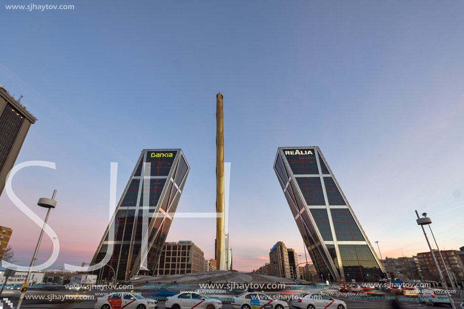 MADRID, SPAIN - JANUARY 23, 2018:  Sunrise view of Gate of Europe (KIO Towers) and Obelisk of Calatrava at Paseo de la Castellana street in City of Madrid, Spain