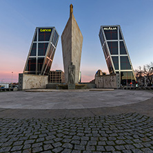 MADRID, SPAIN - JANUARY 23, 2018:  Sunrise view of Gate of Europe (KIO Towers) and Monument to Jose Calvo Sotelo at Paseo de la Castellana street in City of Madrid, Spain