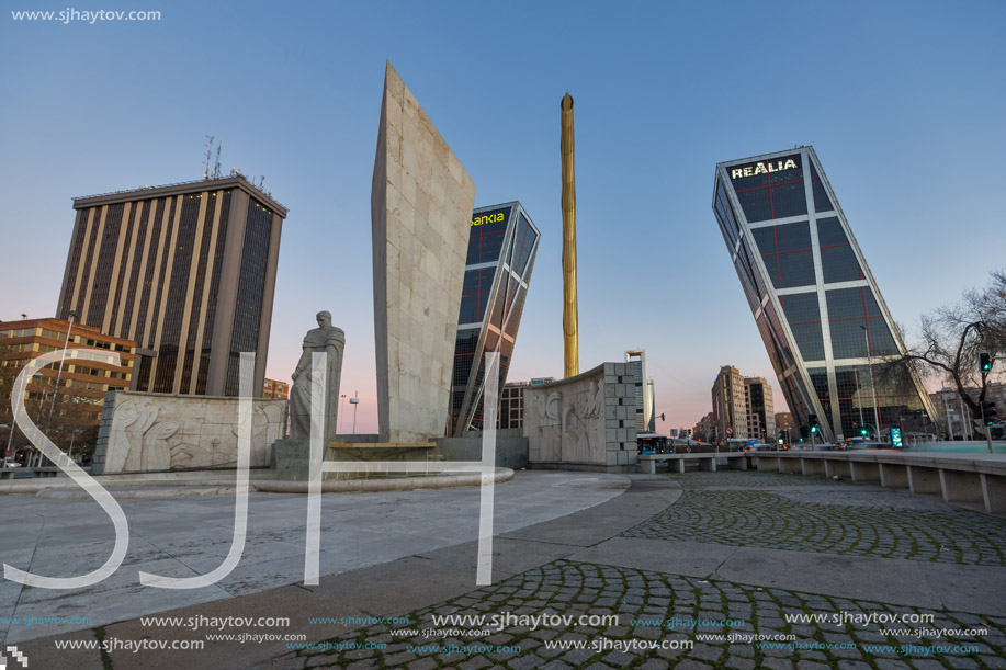 MADRID, SPAIN - JANUARY 23, 2018:  Sunrise view of Gate of Europe (KIO Towers) and Monument to Jose Calvo Sotelo at Paseo de la Castellana street in City of Madrid, Spain