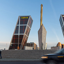 MADRID, SPAIN - JANUARY 23, 2018:  Sunrise view of Gate of Europe (KIO Towers) and Monument to Jose Calvo Sotelo at Paseo de la Castellana street in City of Madrid, Spain