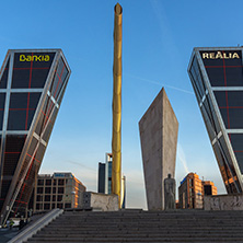 MADRID, SPAIN - JANUARY 23, 2018:  Sunrise view of Gate of Europe (KIO Towers) and Monument to Jose Calvo Sotelo at Paseo de la Castellana street in City of Madrid, Spain