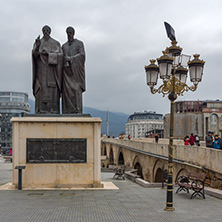 SKOPJE, REPUBLIC OF MACEDONIA - FEBRUARY 24, 2018:  Monument of St. Cyril and Methodius and Old Stone Bridge in city of  Skopje, Republic of Macedonia