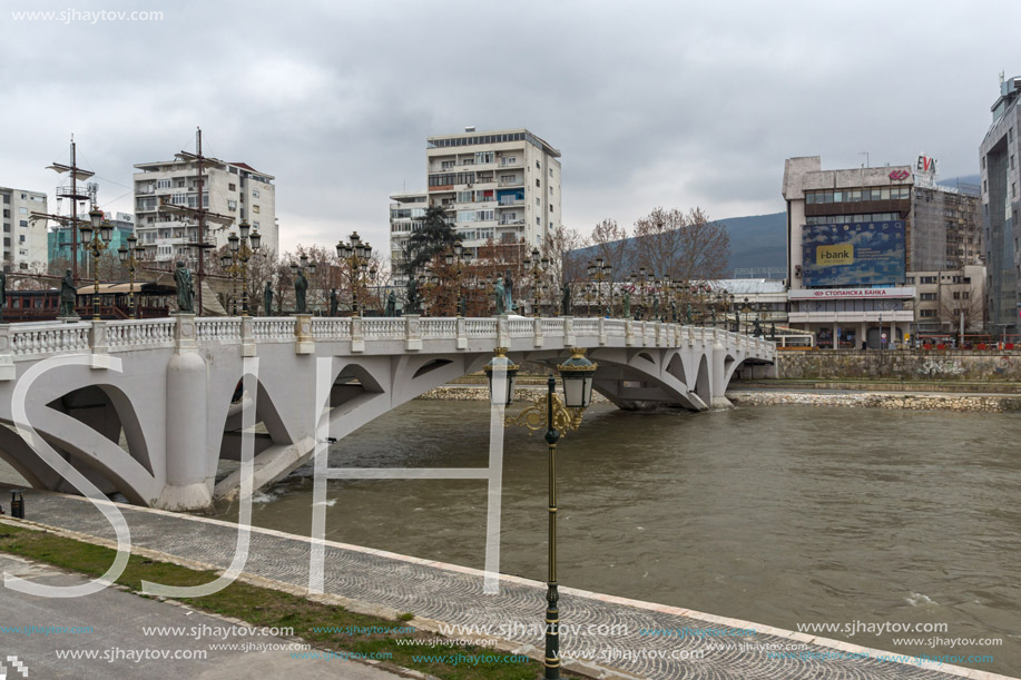 SKOPJE, REPUBLIC OF MACEDONIA - FEBRUARY 24, 2018:  The Bridge of Civilizations and Vardar River in city of  Skopje, Republic of Macedonia