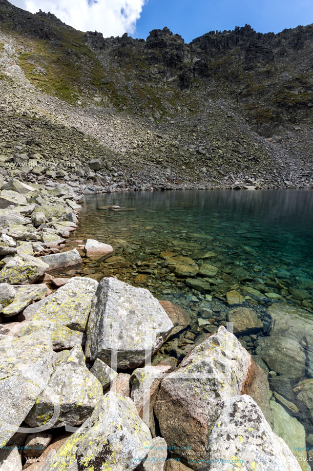 Amazing panoramic view of Ledenoto (Ice) Lake and clouds over Musala Peak, Rila mountain, Bulgaria