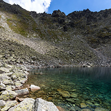 Amazing panoramic view of Ledenoto (Ice) Lake and clouds over Musala Peak, Rila mountain, Bulgaria