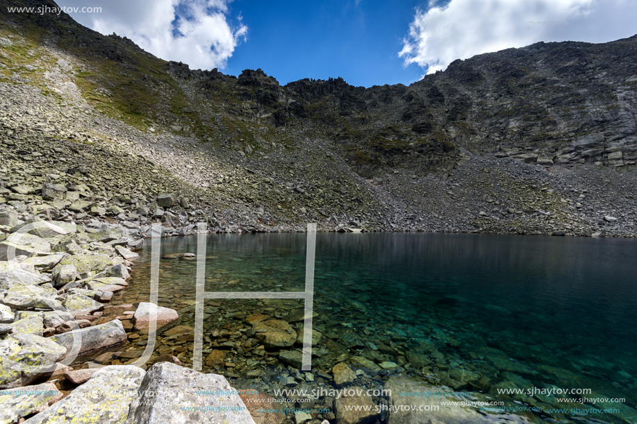 Amazing panoramic view of Ledenoto (Ice) Lake and clouds over Musala Peak, Rila mountain, Bulgaria