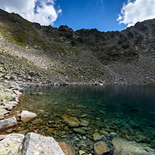 Amazing panoramic view of Ledenoto (Ice) Lake and clouds over Musala Peak, Rila mountain, Bulgaria