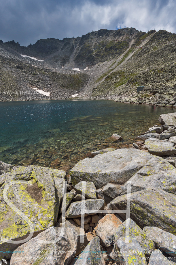 Amazing panoramic view of Ledenoto (Ice) Lake and clouds over Musala Peak, Rila mountain, Bulgaria