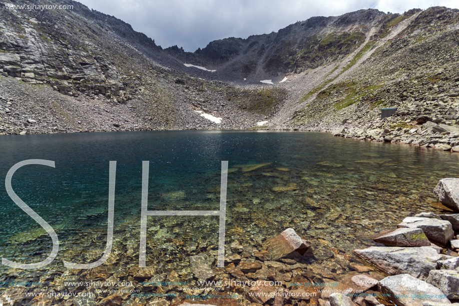 Amazing panoramic view of Ledenoto (Ice) Lake and clouds over Musala Peak, Rila mountain, Bulgaria