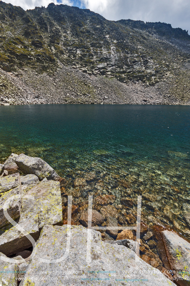 Amazing panoramic view of Ledenoto (Ice) Lake and clouds over Musala Peak, Rila mountain, Bulgaria