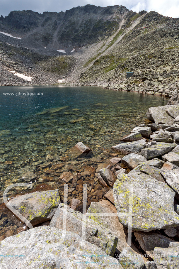 Amazing panoramic view of Ledenoto (Ice) Lake and clouds over Musala Peak, Rila mountain, Bulgaria