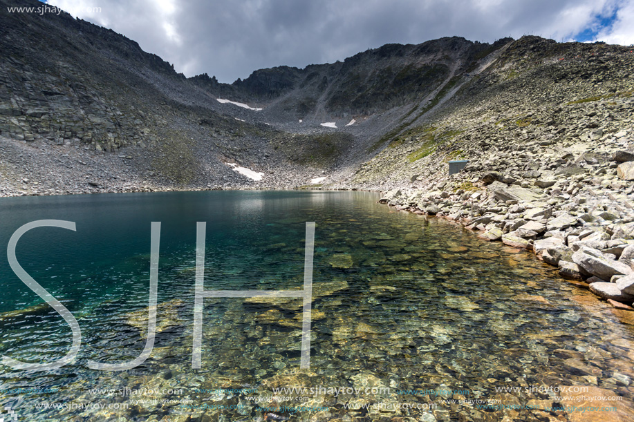 Amazing panoramic view of Ledenoto (Ice) Lake and clouds over Musala Peak, Rila mountain, Bulgaria
