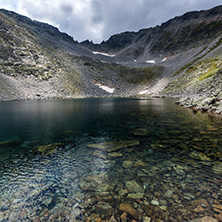 Amazing panoramic view of Ledenoto (Ice) Lake and clouds over Musala Peak, Rila mountain, Bulgaria