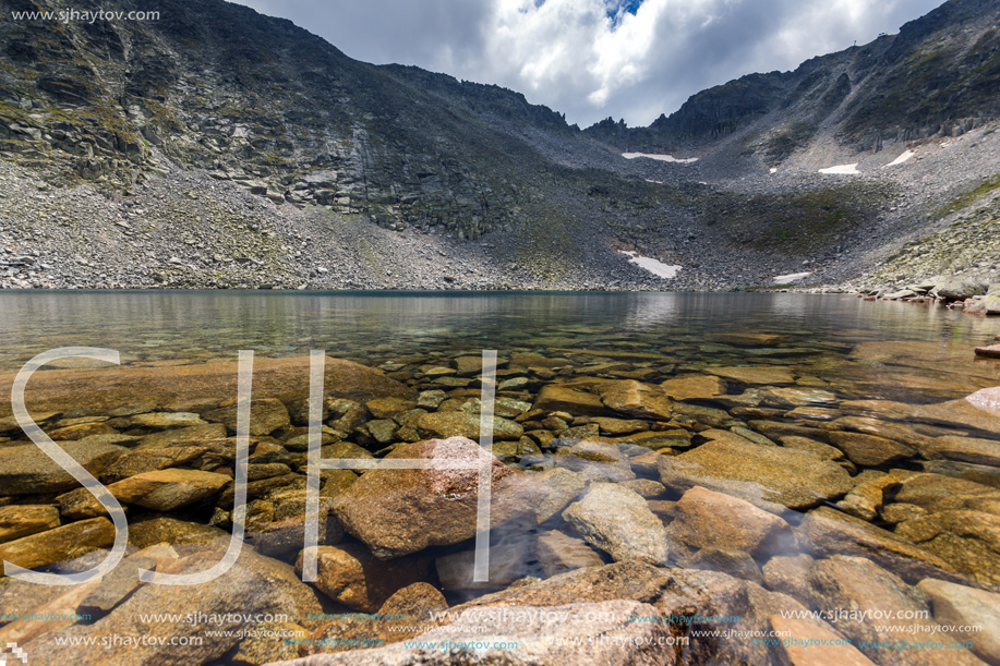 Amazing panoramic view of Ledenoto (Ice) Lake and clouds over Musala Peak, Rila mountain, Bulgaria