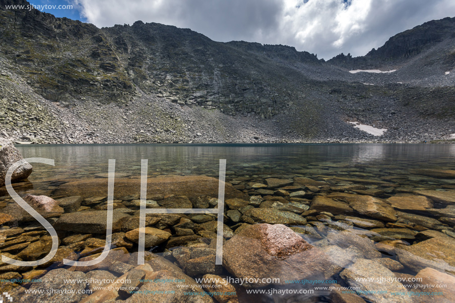 Amazing panoramic view of Ledenoto (Ice) Lake and clouds over Musala Peak, Rila mountain, Bulgaria