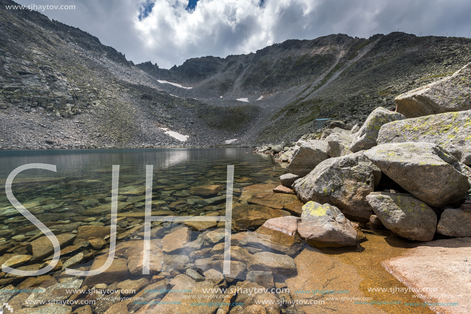 Amazing panoramic view of Ledenoto (Ice) Lake and clouds over Musala Peak, Rila mountain, Bulgaria