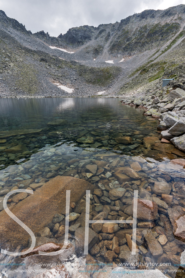 Amazing panoramic view of Ledenoto (Ice) Lake and clouds over Musala Peak, Rila mountain, Bulgaria