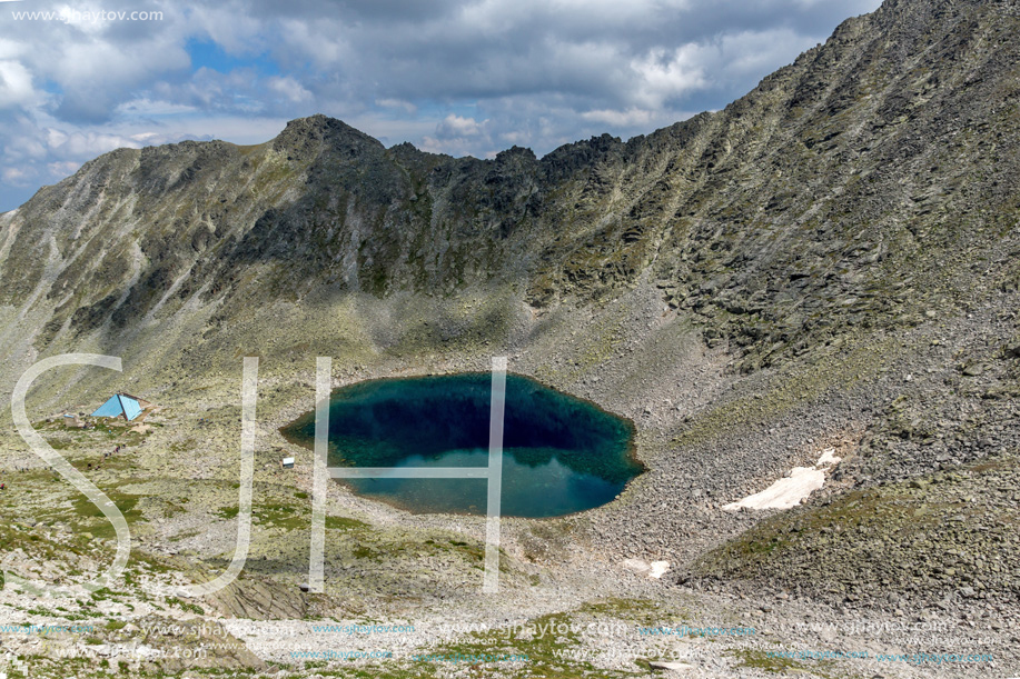 Amazing panoramic view of Ledenoto (Ice) Lake and clouds over Musala Peak, Rila mountain, Bulgaria