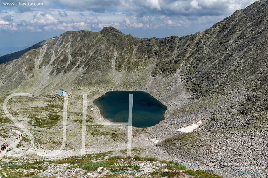 Amazing panoramic view of Ledenoto (Ice) Lake and clouds over Musala Peak, Rila mountain, Bulgaria