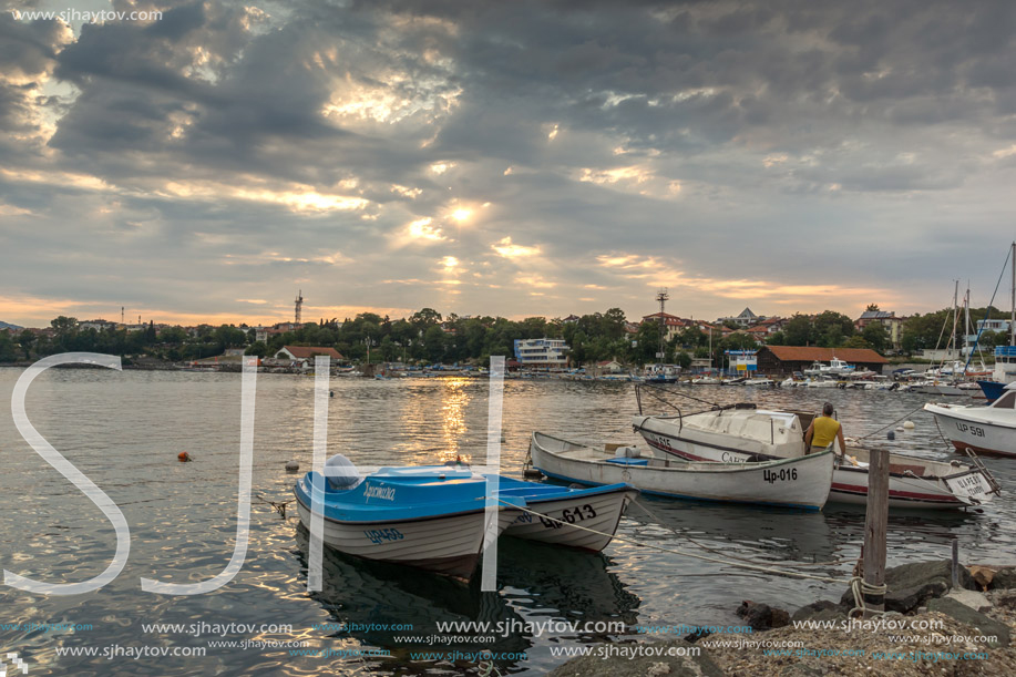 TSAREVO, BULGARIA - JUNE 28, 2013: Sunset at Old boat at the port town of Tsarevo, Burgas Region, Bulgaria