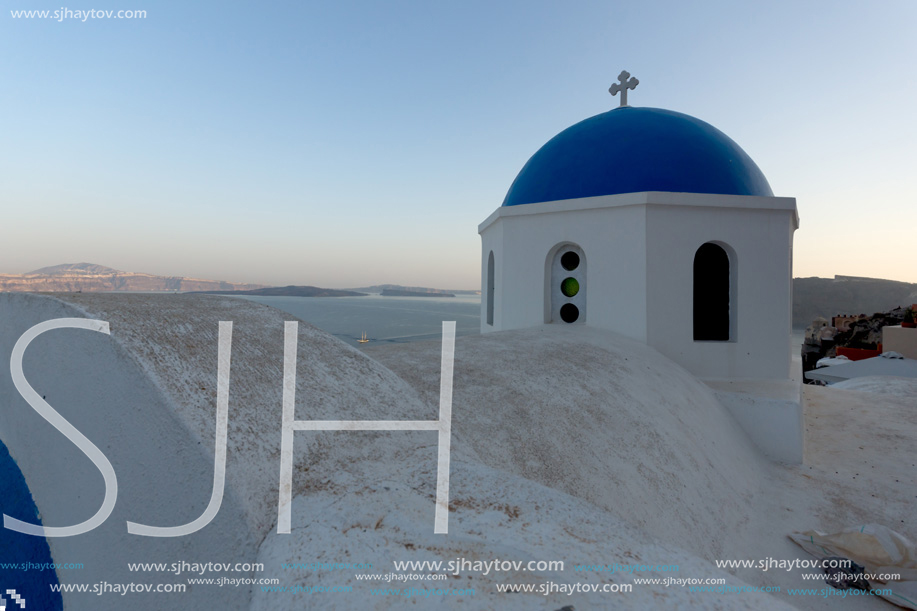 White Orthodox church in town of Oia, Santorini island, Thira, Cyclades, Greece