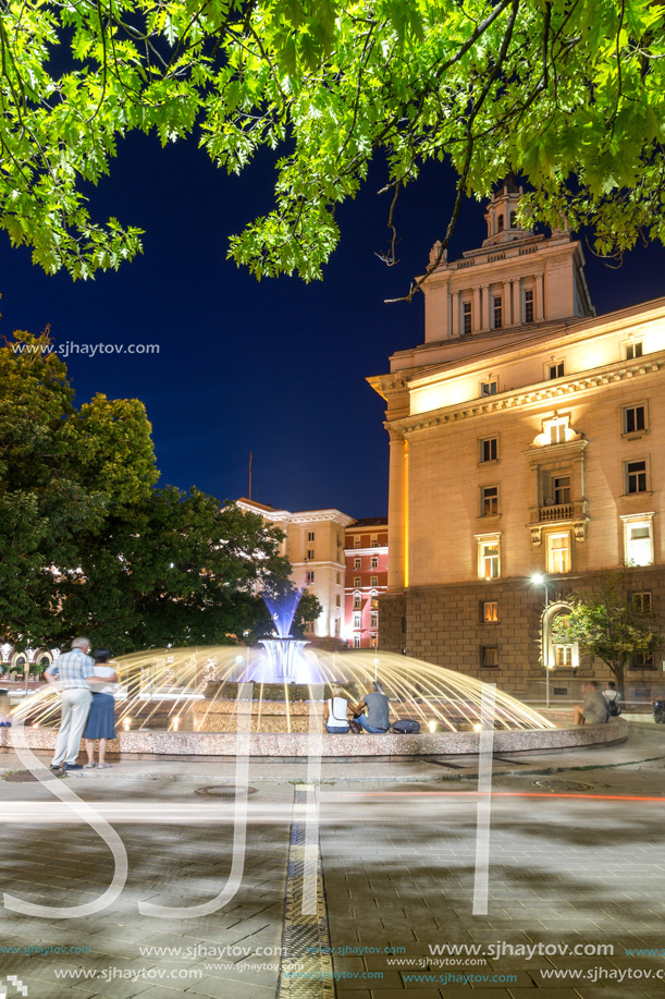 SOFIA, BULGARIA - JULY 21, 2017: Night photo of Fountain in front of The Building of the Presidency and Former Communist Party House in Sofia, Bulgaria
