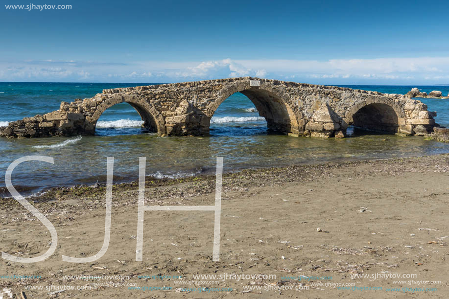 Seascape with medieval bridge in the water at Argassi beach, Zakynthos island, Greece