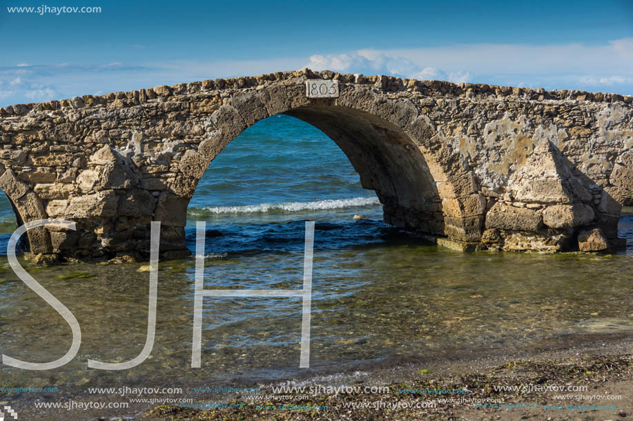 Seascape with medieval bridge in the water at Argassi beach, Zakynthos island, Greece