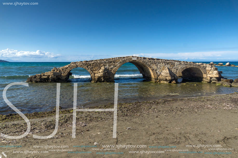 Seascape with medieval bridge in the water at Argassi beach, Zakynthos island, Greece