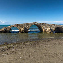 Seascape with medieval bridge in the water at Argassi beach, Zakynthos island, Greece