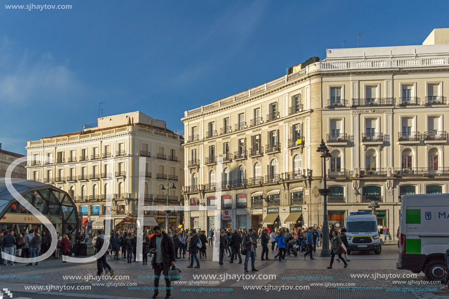 MADRID, SPAIN - JANUARY 23, 2018:  Sunset view of walking people at Puerta del Sol in Madrid, Spain