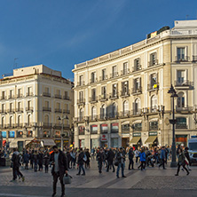 MADRID, SPAIN - JANUARY 23, 2018:  Sunset view of walking people at Puerta del Sol in Madrid, Spain