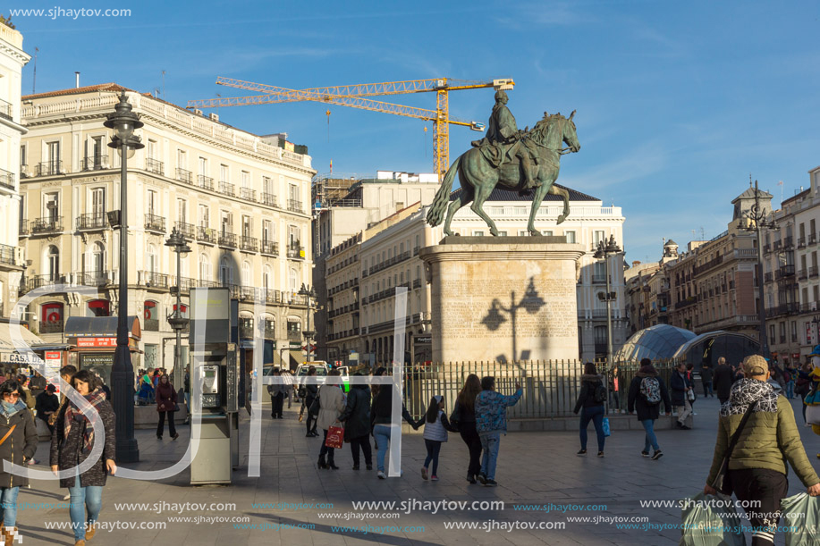 MADRID, SPAIN - JANUARY 23, 2018:  Sunset view of walking people at Puerta del Sol in Madrid, Spain