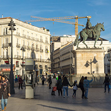 MADRID, SPAIN - JANUARY 23, 2018:  Sunset view of walking people at Puerta del Sol in Madrid, Spain