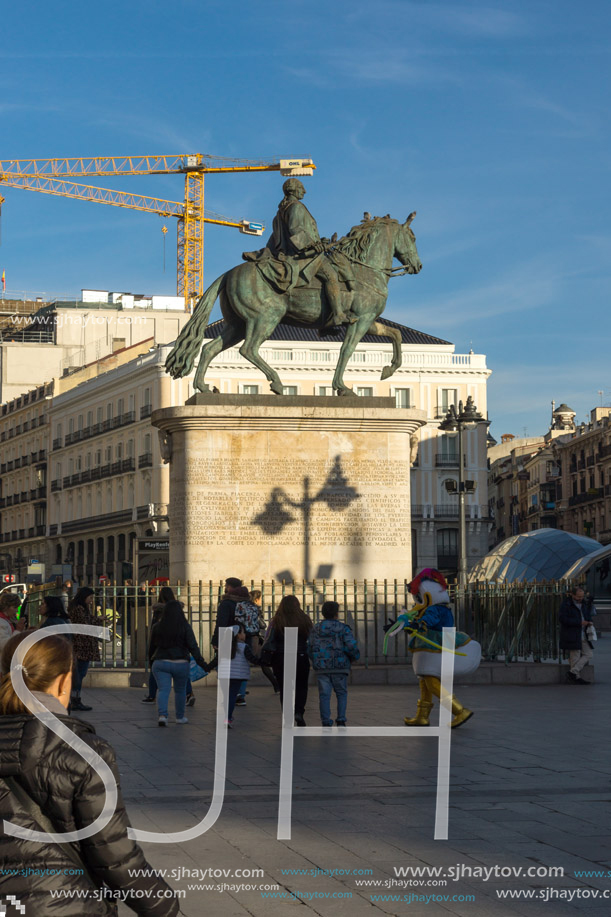 MADRID, SPAIN - JANUARY 23, 2018:  Sunset view of walking people at Puerta del Sol in Madrid, Spain