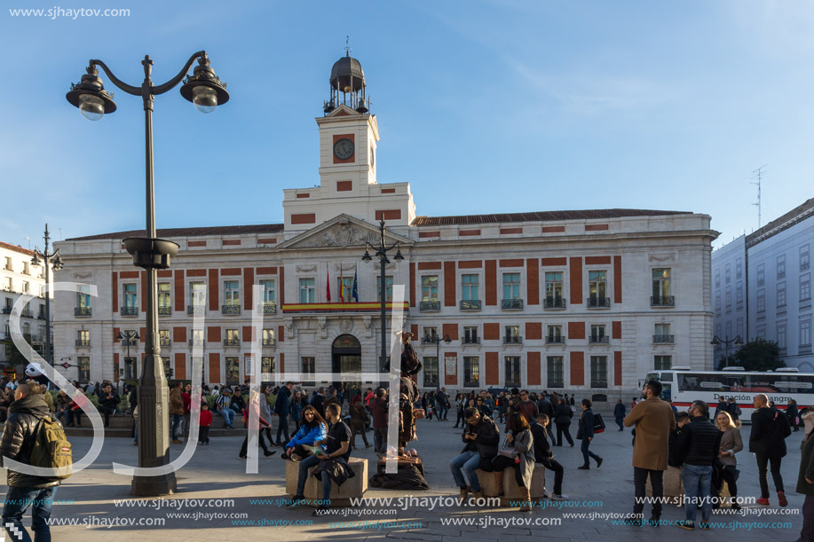 MADRID, SPAIN - JANUARY 23, 2018:  Sunset view of walking people at Puerta del Sol in Madrid, Spain