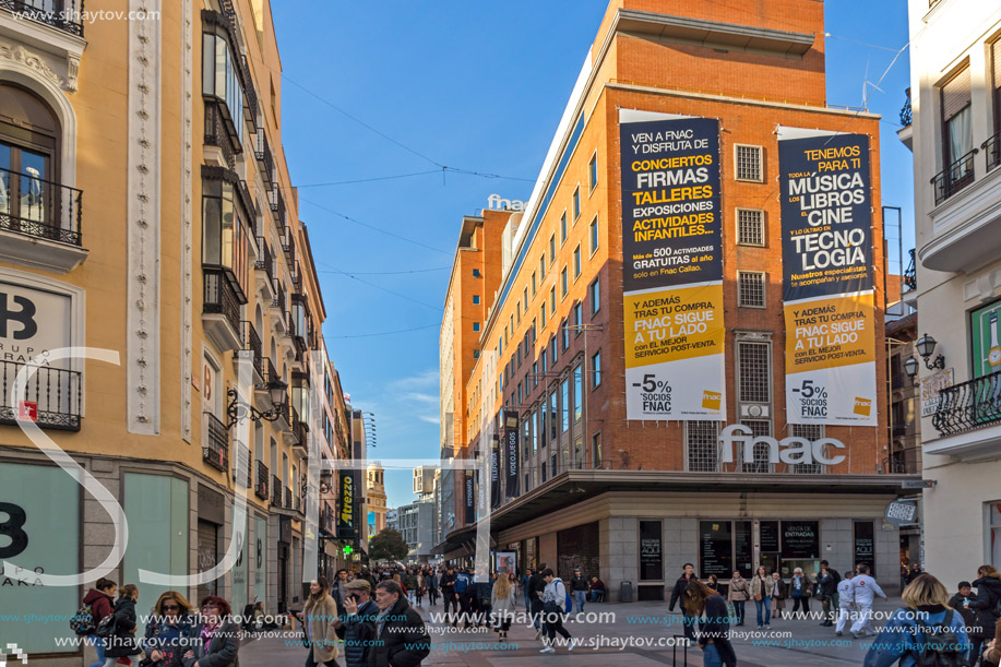 MADRID, SPAIN - JANUARY 23, 2018: Sunset view of walking people at Callao Square (Plaza del Callao) in City of Madrid, Spain