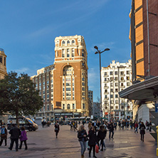 MADRID, SPAIN - JANUARY 23, 2018: Sunset view of walking people at Callao Square (Plaza del Callao) in City of Madrid, Spain