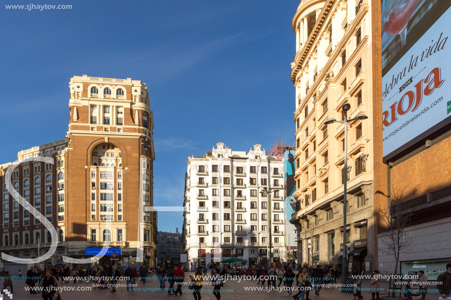 MADRID, SPAIN - JANUARY 23, 2018: Sunset view of walking people at Callao Square (Plaza del Callao) in City of Madrid, Spain