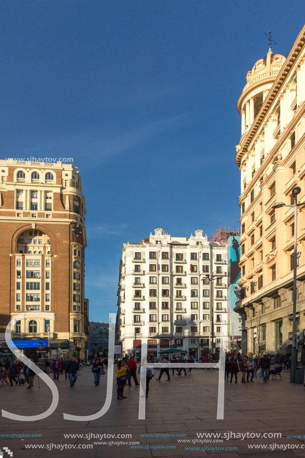 MADRID, SPAIN - JANUARY 23, 2018: Sunset view of walking people at Callao Square (Plaza del Callao) in City of Madrid, Spain