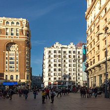 MADRID, SPAIN - JANUARY 23, 2018: Sunset view of walking people at Callao Square (Plaza del Callao) in City of Madrid, Spain