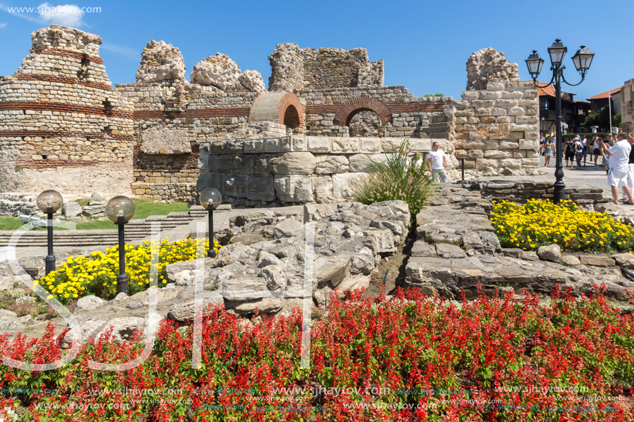 NESSEBAR, BULGARIA - AUGUST 12, 2018: Tourist visiting ruins of Ancient Fortifications at the entrance of old town of Nessebar, Burgas Region, Bulgaria