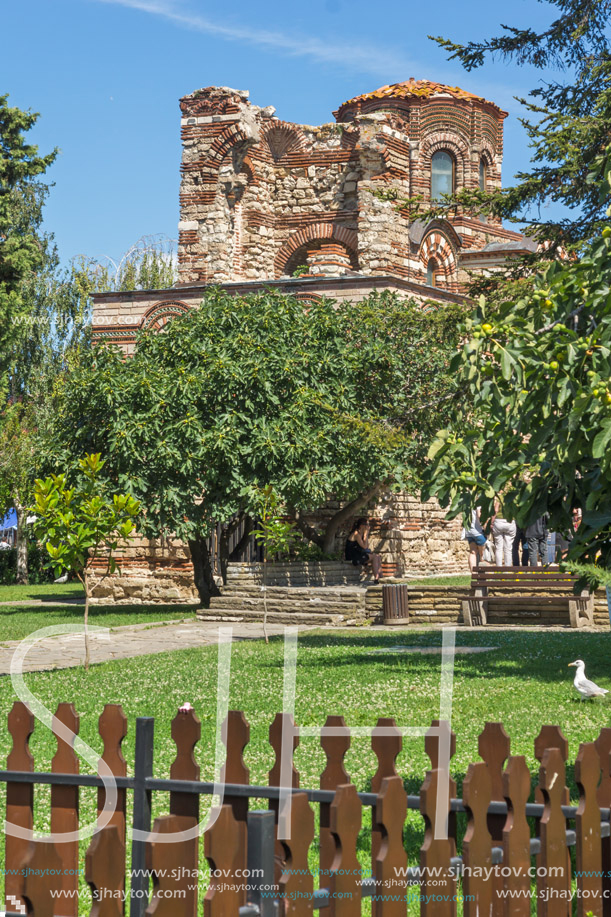 NESSEBAR, BULGARIA - AUGUST 12, 2018: Flower garden in front of Ancient Church of Christ Pantocrator in the town of Nessebar, Burgas Region, Bulgaria