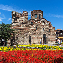 NESSEBAR, BULGARIA - AUGUST 12, 2018: Flower garden in front of Ancient Church of Christ Pantocrator in the town of Nessebar, Burgas Region, Bulgaria