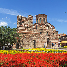 NESSEBAR, BULGARIA - AUGUST 12, 2018: Flower garden in front of Ancient Church of Christ Pantocrator in the town of Nessebar, Burgas Region, Bulgaria