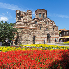 NESSEBAR, BULGARIA - AUGUST 12, 2018: Flower garden in front of Ancient Church of Christ Pantocrator in the town of Nessebar, Burgas Region, Bulgaria