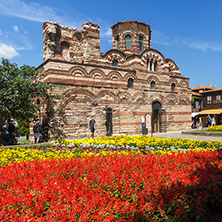 NESSEBAR, BULGARIA - AUGUST 12, 2018: Flower garden in front of Ancient Church of Christ Pantocrator in the town of Nessebar, Burgas Region, Bulgaria